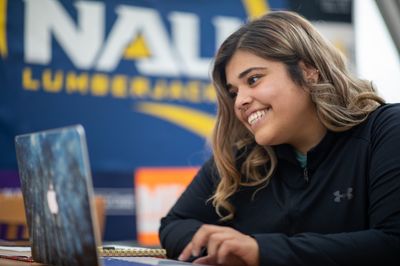 An NAU student signs up for scholarships with the help of their online advisor.