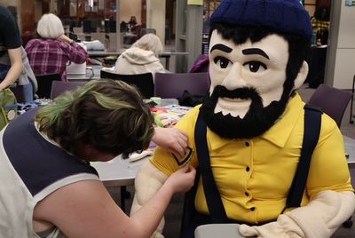 Louie the Lumberjack getting a patch sewn on during a RepairLab